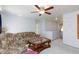 Living room featuring carpet flooring, ceiling fan, and a couch with floral pattern, showcasing a relaxed living space at 3404 Brayton Mist Dr, North Las Vegas, NV 89081