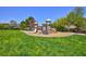 Community playground in a lush green space, perfect for Gathering fun and recreation at 3404 Brayton Mist Dr, North Las Vegas, NV 89081