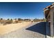 Spacious backyard with desert landscaping, gravel accents, and a gazebo, perfect for outdoor enjoyment and entertaining at 3430 Flagstone Ct, Pahrump, NV 89048
