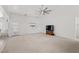 Spacious living room with neutral carpet, a large ceiling fan, and ample space for relaxation and entertainment at 3430 Flagstone Ct, Pahrump, NV 89048