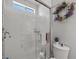 Bathroom shower with glass door, white subway tile and a decorative wreath at 3430 Flagstone Ct, Pahrump, NV 89048