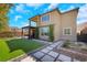 This backyard features an artificial lawn, rock garden, stone tile, and a patio with pergola-covered seating at 3512 Portiani Dr, Las Vegas, NV 89141