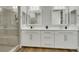 Bathroom features walk-in shower with glass enclosure, double sinks and wood-look floor at 3512 Portiani Dr, Las Vegas, NV 89141