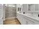 Bathroom features walk-in shower with glass enclosure, double sinks and wood-look floor at 3512 Portiani Dr, Las Vegas, NV 89141