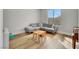 Bedroom with wood floors, grey sectional couch, and a table set at 3512 Portiani Dr, Las Vegas, NV 89141