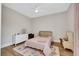Bright bedroom with wooden floors, ceiling fan, and white trim at 3512 Portiani Dr, Las Vegas, NV 89141