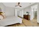 Bedroom features wood-look floors and natural light from adjacent bathroom at 3512 Portiani Dr, Las Vegas, NV 89141