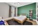 Bedroom features green accent wall, window with view, and modern ceiling fan at 3512 Portiani Dr, Las Vegas, NV 89141