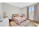 Bright bedroom with wooden floors, a ceiling fan, and a light pink bedspread at 3512 Portiani Dr, Las Vegas, NV 89141