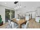 Open concept dining area with backyard access and views into living and kitchen spaces at 3512 Portiani Dr, Las Vegas, NV 89141