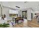 Dining room with modern wood table, bench, and sliding doors to the outdoor patio at 3512 Portiani Dr, Las Vegas, NV 89141