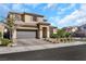 Two-story home with desert landscaping, tile roof, and a two car garage on a sunny day at 3512 Portiani Dr, Las Vegas, NV 89141