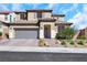 Two-story home with desert landscaping, tile roof, and a two car garage on a sunny day at 3512 Portiani Dr, Las Vegas, NV 89141