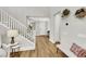 Bright foyer features wood floors, staircase with white railing, and stylish decor, creating a welcoming entrance at 3512 Portiani Dr, Las Vegas, NV 89141
