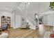 Inviting foyer featuring a staircase with white railings, modern decor, and plenty of natural light, creating a welcoming space at 3512 Portiani Dr, Las Vegas, NV 89141