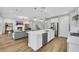 Open-concept kitchen with a large island, stainless steel appliances, and hardwood flooring at 3512 Portiani Dr, Las Vegas, NV 89141