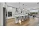 Modern kitchen featuring white cabinets, stainless steel appliances, and a large island with bar seating, perfect for cooking at 3512 Portiani Dr, Las Vegas, NV 89141