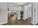 Open living room featuring wood floors, white staircase, and view of the backyard at 3512 Portiani Dr, Las Vegas, NV 89141