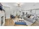 Open-concept living room with hardwood floors, fireplace, and views into the kitchen, perfect for modern living and entertaining at 3512 Portiani Dr, Las Vegas, NV 89141