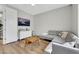 Cozy living room with hardwood floors, gray sofa, and a TV on the wall, perfect for relaxation and entertainment at 3512 Portiani Dr, Las Vegas, NV 89141