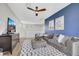 Bright sitting area featuring a vibrant accent wall, plush seating, a ceiling fan and a balcony at 3512 Portiani Dr, Las Vegas, NV 89141