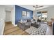 Stylish living room featuring plush seating, a vibrant accent wall, and sliding doors to the outside at 3512 Portiani Dr, Las Vegas, NV 89141