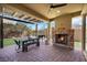 Outdoor patio area with fireplace, ceiling fan, outdoor grill, and dining table at 3512 Portiani Dr, Las Vegas, NV 89141