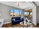 Bright seating area with couch, large window, and balcony access at 3512 Portiani Dr, Las Vegas, NV 89141