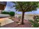 Backyard with patio, desert landscaping, tree, and views of the Las Vegas skyline at 3942 Delos Dr, Las Vegas, NV 89103