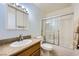 Bathroom featuring a single sink vanity with a large mirror, tiled floors, and a shower-tub combination at 3942 Delos Dr, Las Vegas, NV 89103