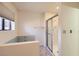 Bright bathroom featuring a glass-doored shower and tiled tub at 3942 Delos Dr, Las Vegas, NV 89103
