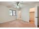 Bright bedroom featuring neutral walls, carpet, and a ceiling fan with a closet at 3942 Delos Dr, Las Vegas, NV 89103