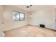 Bedroom with neutral carpet, a light fixture, and a window offering natural light at 3942 Delos Dr, Las Vegas, NV 89103