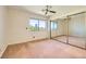 Bright bedroom features large window view and mirrored closet at 3942 Delos Dr, Las Vegas, NV 89103