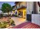 Backyard patio with desert landscaping, balcony, and gray stucco exterior at 3942 Delos Dr, Las Vegas, NV 89103