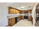 Kitchen features classic oak cabinets, tile floors, stainless appliances, and plenty of counter space at 3942 Delos Dr, Las Vegas, NV 89103