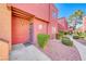 Condominium exterior with grey door and tidy landscaping at 4050 Pacific Harbors Dr # 107, Las Vegas, NV 89121