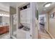 Hallway view of a stacked washer and dryer, bathroom, and living area for convenient living at 4050 Pacific Harbors Dr # 107, Las Vegas, NV 89121