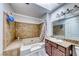 Bathroom with tub-shower combo, ceramic tile surround, and a granite-topped vanity at 4050 Pacific Harbors Dr # 245, Las Vegas, NV 89121