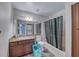Clean bathroom featuring tub with shower, granite vanity, and adjacent stacked washer-dryer at 4050 Pacific Harbors Dr # 245, Las Vegas, NV 89121