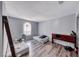 Spare bedroom with two beds, wood floors, and a bright window at 4050 Pacific Harbors Dr # 245, Las Vegas, NV 89121