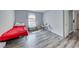 Minimalist bedroom with light grey walls, wood floors, and a bright window at 4050 Pacific Harbors Dr # 245, Las Vegas, NV 89121