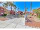Charming clubhouse entrance with mature landscaping and an attractive, eye-catching architectural design at 4050 Pacific Harbors Dr # 245, Las Vegas, NV 89121