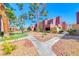 Exterior of a well-maintained apartment complex with mature trees and manicured landscaping at 4050 Pacific Harbors Dr # 245, Las Vegas, NV 89121
