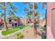 Exterior view of desert landscaping, mature trees, and a path to residential units at 4050 Pacific Harbors Dr # 245, Las Vegas, NV 89121
