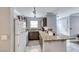 Kitchen with white appliances, granite counters, breakfast bar, and ample cabinet space at 4050 Pacific Harbors Dr # 245, Las Vegas, NV 89121