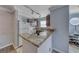 Efficient kitchen features granite counters, track lighting, and stainless steel microwave oven at 4050 Pacific Harbors Dr # 245, Las Vegas, NV 89121