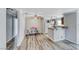 Open-concept kitchen and dining area with modern lighting and neutral color palette at 4050 Pacific Harbors Dr # 245, Las Vegas, NV 89121