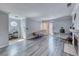 Spacious living room features wood-look floors, fireplace, and sliding door to patio at 4050 Pacific Harbors Dr # 245, Las Vegas, NV 89121