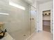 Modern bathroom with a glass-enclosed shower, tiled walls, and a view into the walk-in closet at 4180 E Brusca Way, Pahrump, NV 89061